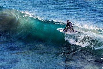 Man on surfboard, Surfs Up High Tide Phuket