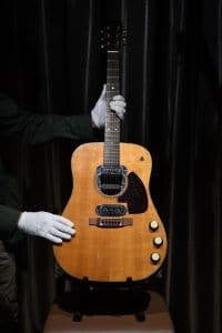 Co-owner of Julien's Auctions, Martin Nolan displays the guitar used by musician Kurt Cobain during Nirvana's famous MTV Unplugged in New York concert in 1993, at the Hard Rock Cafe Piccadilly Circus in central London on May 15, 2020, prior to the auction of the guitar in Beverly Hills in June. - The 1959 Martin D-18E featured in the band's performance in November 1993, five months before Cobain's death at the age of 27. (Photo by DANIEL LEAL-OLIVAS / AFP) (Photo by DANIEL LEAL-OLIVAS/AFP via Getty Images)